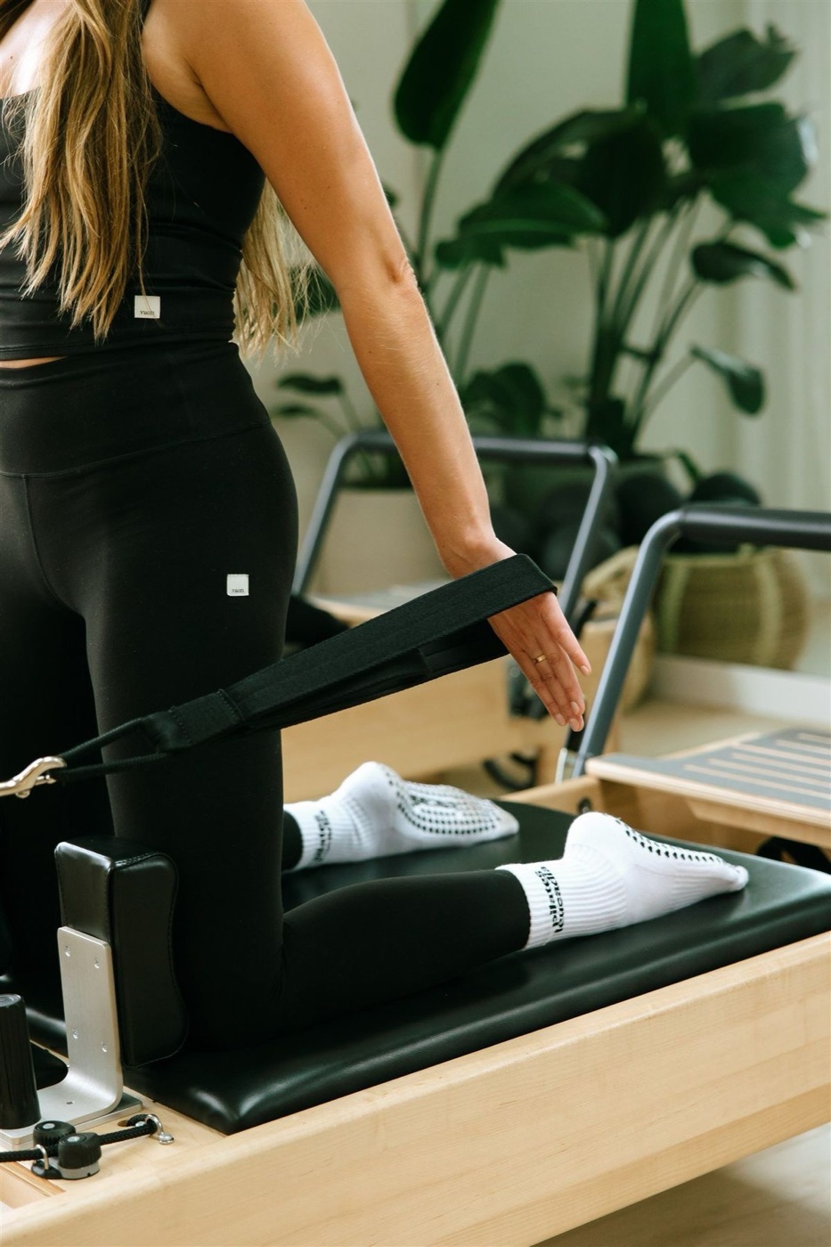 Alumna trabajando en el reformer con correas